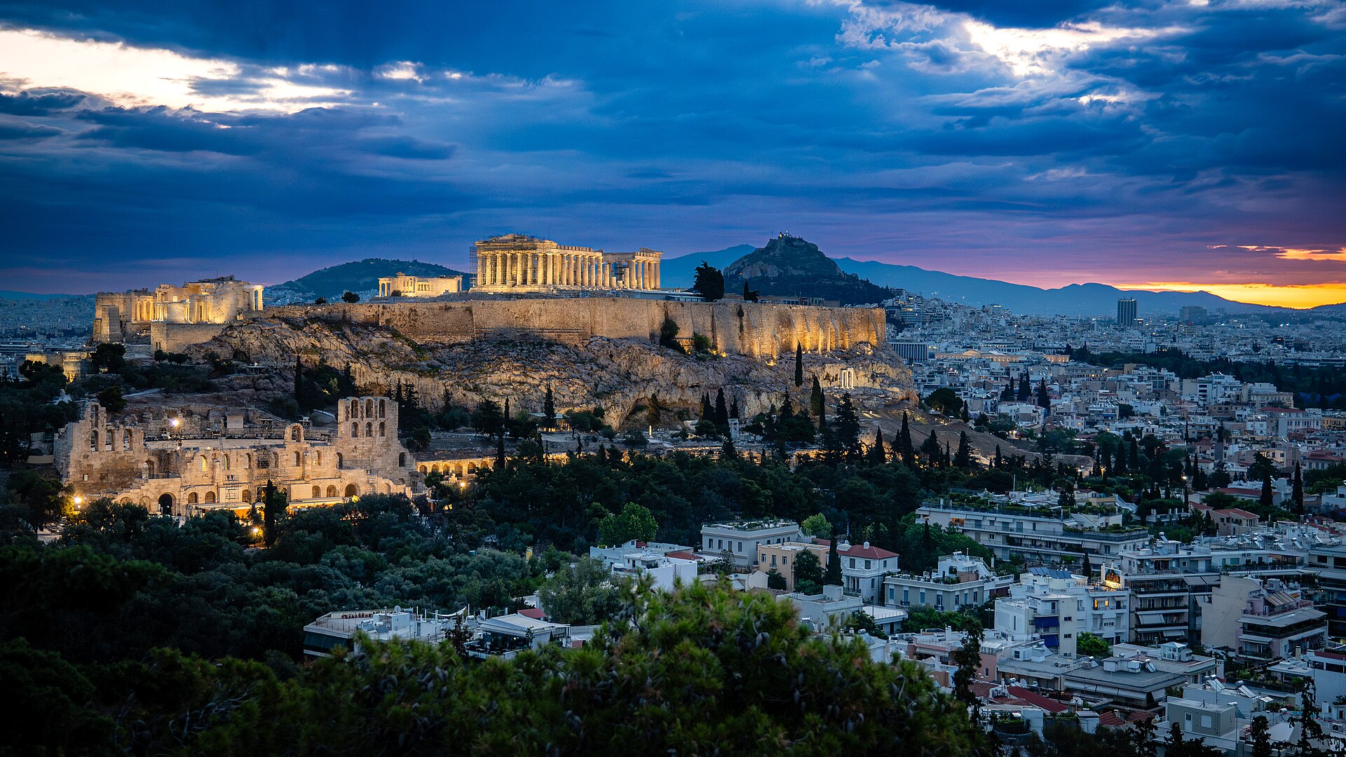 Athens with the Acropolis lit above the city at night